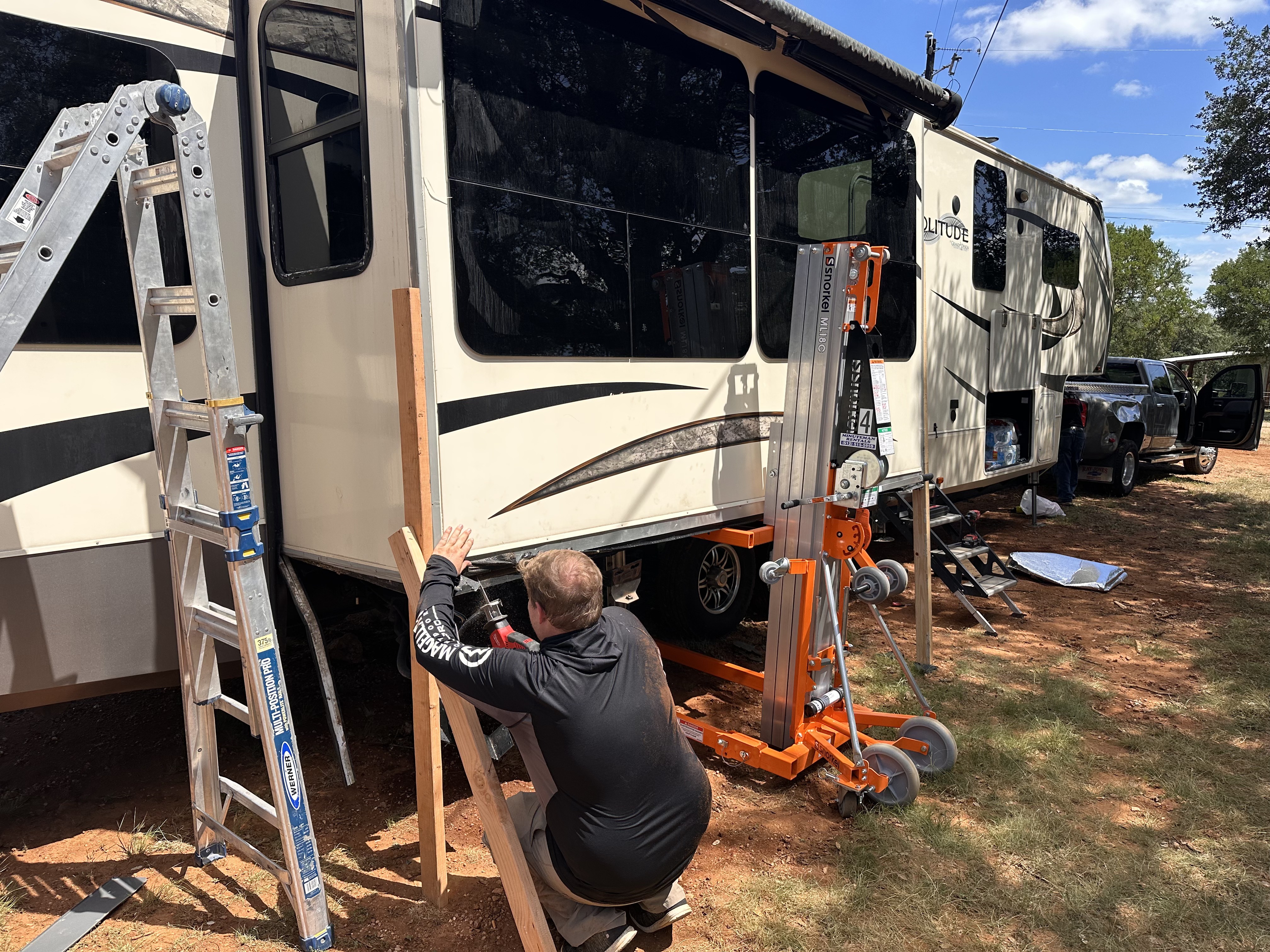 Technician performing RV repair work on a Solitude fifth-wheel