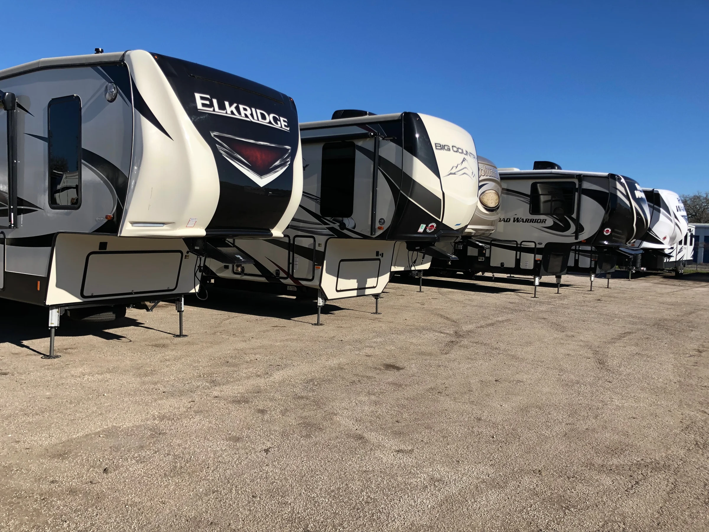 Row of fifth-wheel RVs and travel trailers we service