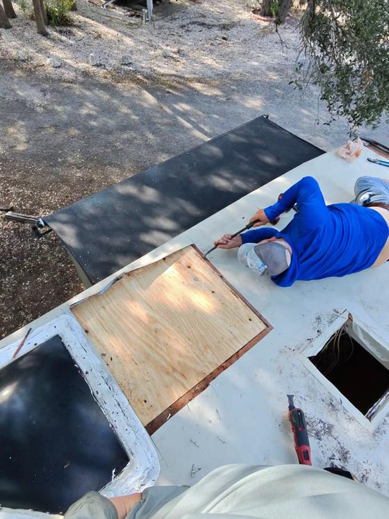 New plywood decking let into an RV roof with the old membrane peeled back