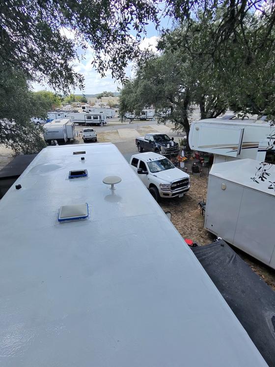 The finished white CrazySeal roof system on an RV, with all vents sealed in